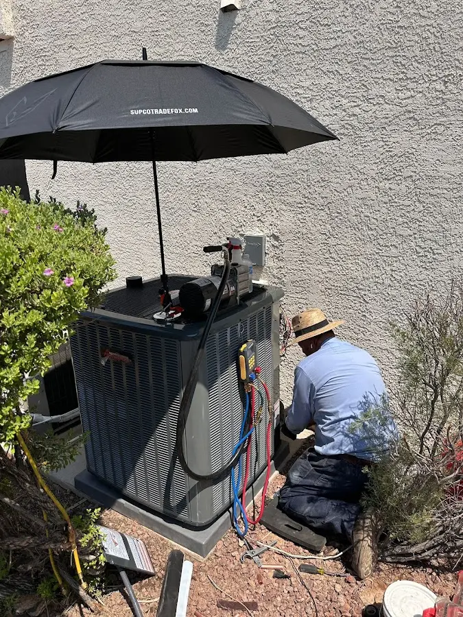 HVAC technician performing outdoor AC maintenance in Oceano